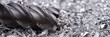 Panoramic image. Silver end mill cutter with metal shavings. Processing of ferrous metals in a factory