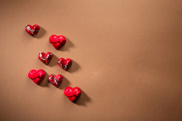 Wall Mural - Sweet gift fot Valentine s Day, candy on brown surface