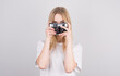 © Studio Nova - Happy smiling young girl holding camera and taking photos