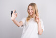 © Studio Nova - Happy smiling young girl holding camera and taking pictures of herself