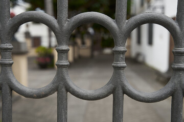 Poster - Selective focus shot of metallic gates on a blurry background o