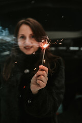 Portrait of a woman with sparklers in her hands