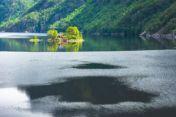 Wall Mural - breathtaking view of small island with red house in lovrafjorden fjord, norway. landscape photograph