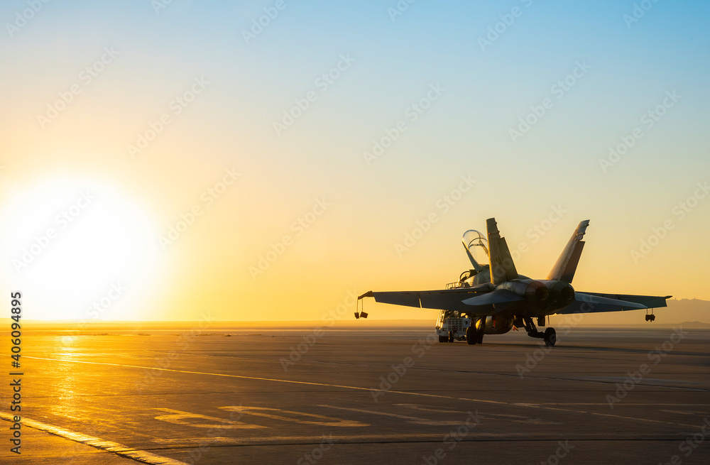 Jet fighter on an aircraft carrier deck against beautiful sunset sky ...