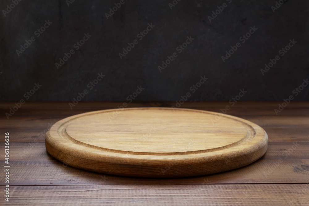 pizza cutting board at wooden table - obrazy, fototapety, plakaty 