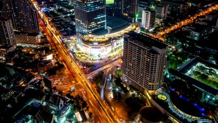 Wall Mural - Bangkok business district city center above Samyan area and traffic, with buildings and skyscrapers, during night – Time Lapse