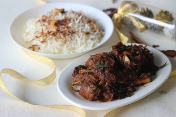 Wall Mural - Aromatic traditional Ghee rice and spicy mutton roast prepared in Kerala style photographed with Christmas settings