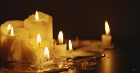 Wall Mural - Candles glowing against dark background