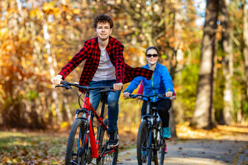 Wall Mural - Healthy lifestyle - people riding bicycles in city park
