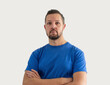 © SolaruS - Caucasian white man portrait, isolated on background. Guy in t shirt with crossed arms.