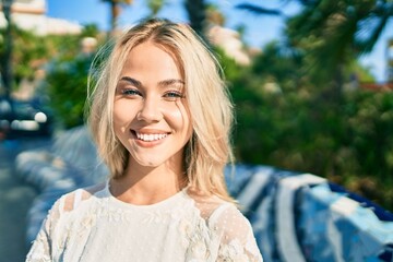 Wall Mural - Young caucasian girl smiling happy walking at street of city.