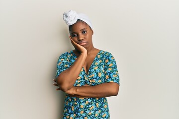 Sticker - Young african woman wearing hair turban and african style thinking looking tired and bored with depression problems with crossed arms.