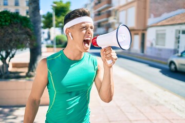 Wall Mural - Young hispanic sportsman smiling happy walking at street of city