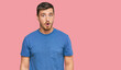 © Krakenimages.com - Handsome caucasian man wearing casual clothes afraid and shocked with surprise expression, fear and excited face.