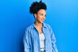 © Krakenimages.com - Young african american girl wearing casual clothes looking away to side with smile on face, natural expression. laughing confident.