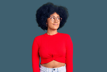 Sticker - Young african american girl wearing casual clothes and glasses smiling looking to the side and staring away thinking.