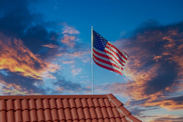 Wall Mural - An American flag flying over a red tile roof on a blue sky