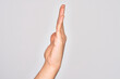 © Krakenimages.com - Hand of caucasian young man showing fingers over isolated white background showing side of stretched hand, pushing and doing stop gesture