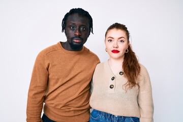 Sticker - Interracial couple wearing casual clothes relaxed with serious expression on face. simple and natural looking at the camera.