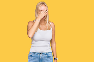 Sticker - Young blonde girl wearing casual style with sleeveless shirt tired rubbing nose and eyes feeling fatigue and headache. stress and frustration concept.