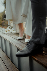 Sticker - Closeup of bride and groom shoes, a wedding in rustic style