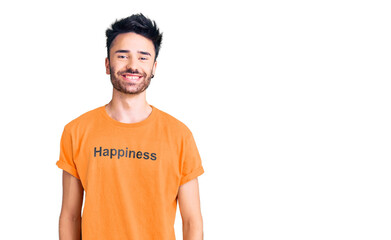 Young hispanic man wearing t shirt with happiness word message with a happy and cool smile on face. lucky person.