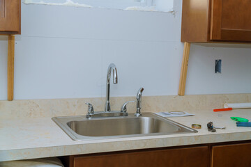 Wall Mural - Installing the kitchen tap and the stainless steel sink