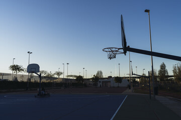 Poster - Beautiful shot of an empty basketball court during sunset