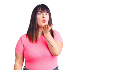 Sticker - Young plus size woman wearing casual clothes looking at the camera blowing a kiss with hand on air being lovely and sexy. love expression.