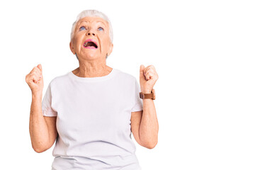 Wall Mural - Senior beautiful woman with blue eyes and grey hair wearing casual white tshirt angry and mad screaming frustrated and furious, shouting with anger. rage and aggressive concept.