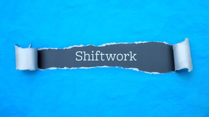 Wall Mural - Shiftwork. Blue torn paper banner with text label. Word in gray hole.