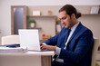 © Elnur - Young male employee working from home in pandemic concept