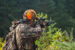 © David - Young hunter aiming rifle in the forest
