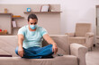 © Elnur - Young man sitting at home during pandemic