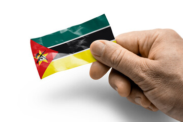 Hand holding a card with a national flag the Mozambique