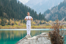 Young Zen Man In Meditation. Outdoor Yoga In Mountain Lake
