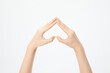 Closeup shot of hands showing a heart upside down isolated on a white background