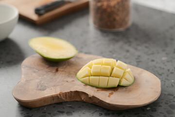 Wall Mural - Ripe green mango sliced on olive wood board