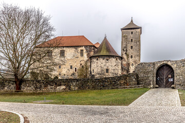 Massive and well fortified medieval Water Castle of Svihov is situated in the Pilsen Region, Czech Republic, Europe. There are water canal around the stone castle. Winter view.