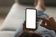 © fizkes - Crop close up back view of woman hold use modern smartphone gadget texting or messaging online. Female user browse internet on cellphone device. Distant communication, mockup white screen concept.