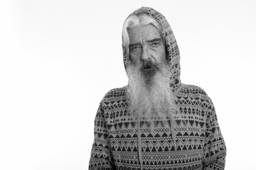 Studio shot of senior bearded man wearing hoodie