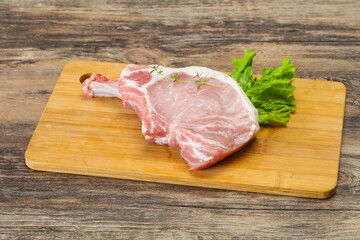 Raw pork bone steak over wooden