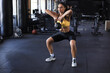 © ty - Sport woman with kettlebell in the gym.