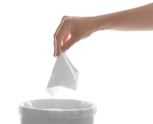 Woman Putting Paper Tissue Into Trash Bin On White Background, Closeup