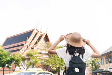 Wall Mural - Rear view of young adult asian traveller woman at Bangkok, Thailand.