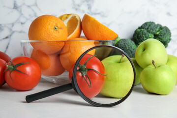 Wall Mural - fresh fruits, vegetables and magnifying glass on white table. poison detection
