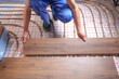 © New Africa - Worker installing new wooden laminate over underfloor heating system, closeup