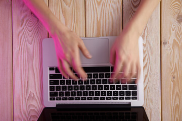 Poster - Image of woman’s hands typing fast on laptop keyboard. View from above. Remote work concept image.