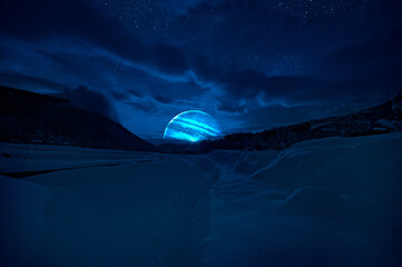 mountain road through the snowy forest on a full moon night. scenic night winter landscape of dark b