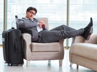 Young businessman in airport business lounge waiting for flight